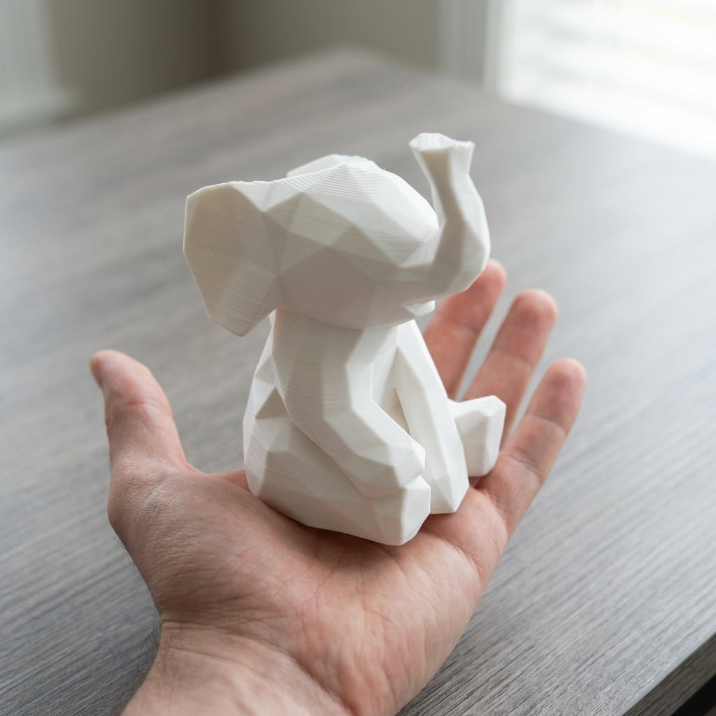 Elephant held in hand showing real-world size (~6cm tall)