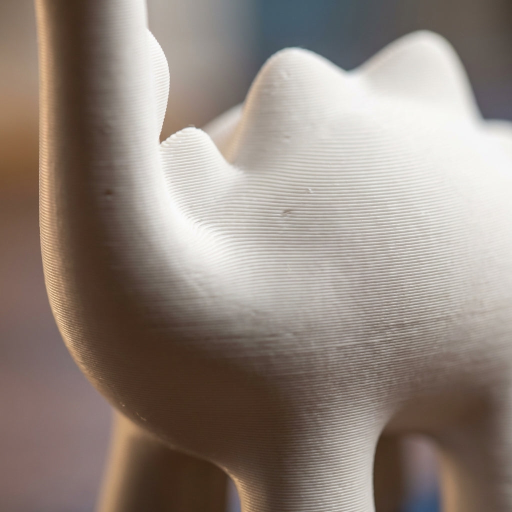 Close-up macro of matte white PLA surface with visible FDM layer lines