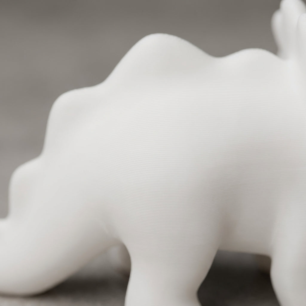 Close-up of matte white PLA surface with subtle layer lines