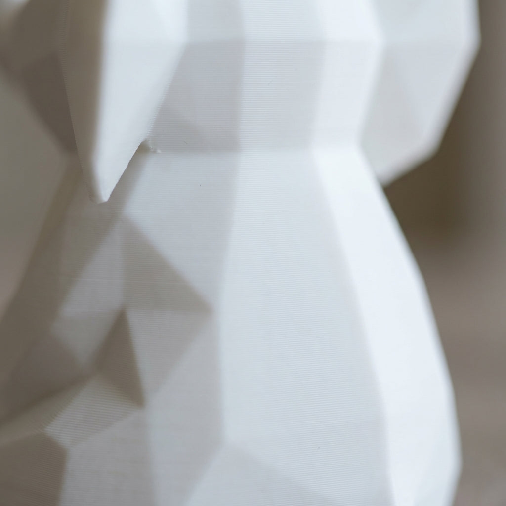 Close-up of matte white PLA surface with subtle layer lines